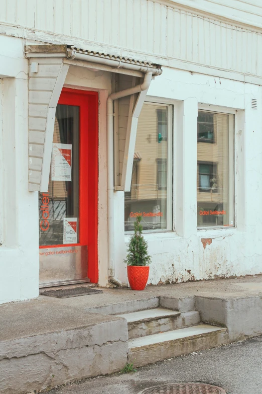 a red door sitting next to a red building