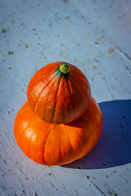 an orange pumpkin is sitting on top of another one