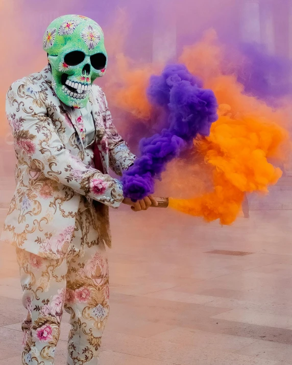 a man is wearing a skull mask and holding a colored item