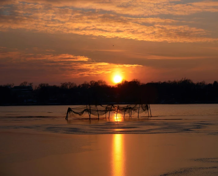 a po of the sun setting on the water