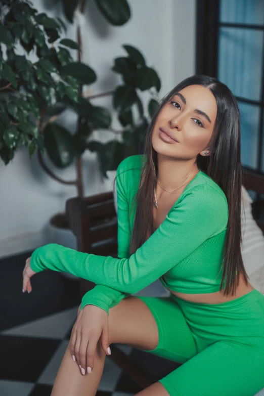 a woman with long hair is posing on a couch