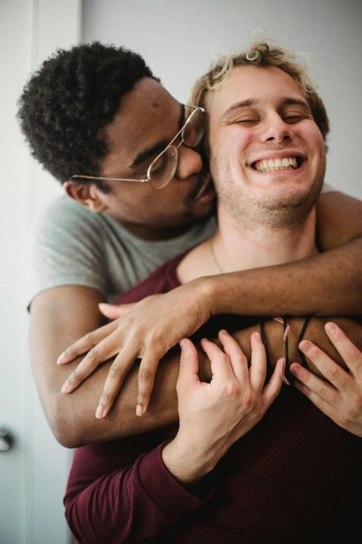 a woman emcing the back of a man while he holds him