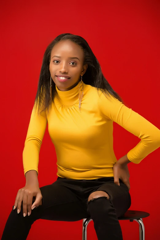 a woman sitting on top of a chair posing