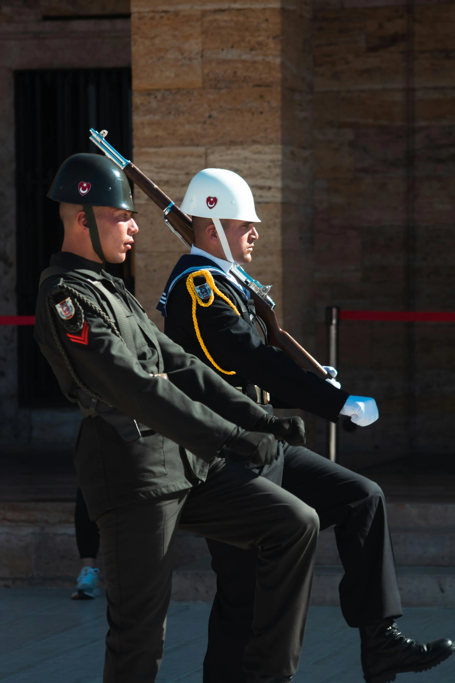 two men in military uniforms standing next to each other