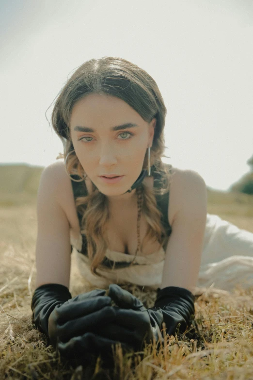 a  laying on top of a dry grass field