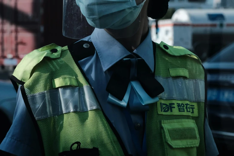 a man wearing a face mask and safety vest