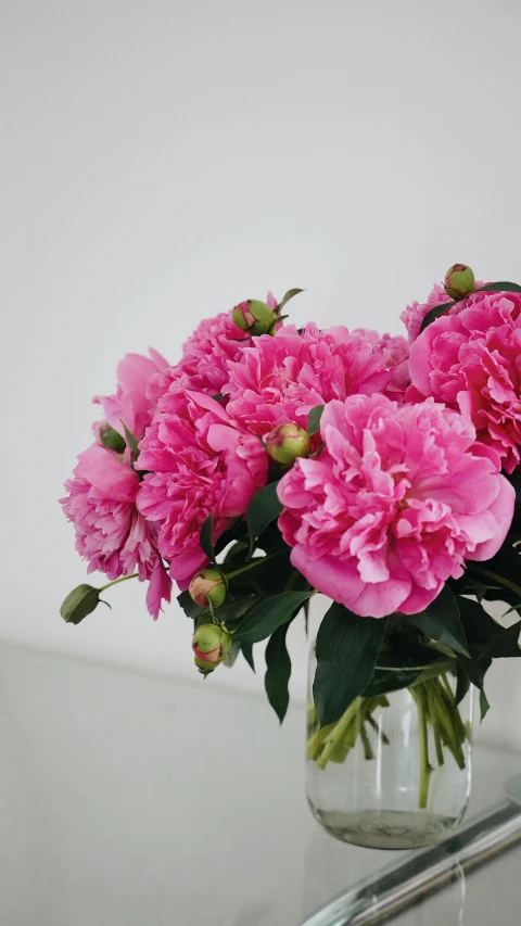 some pink flowers are sitting in a vase