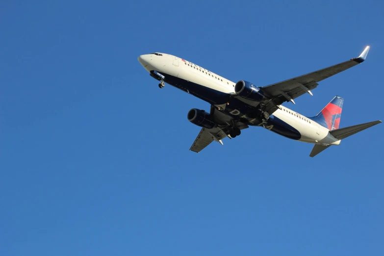 airplane in the air above against a blue sky