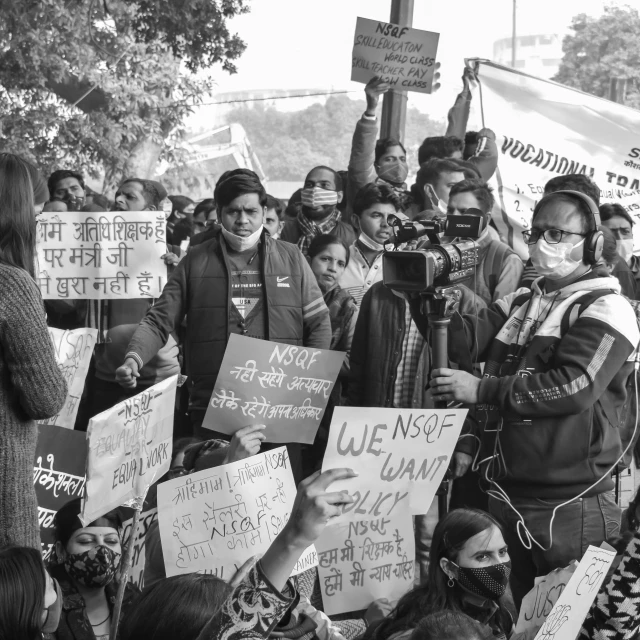 black and white image of many protestors holding signs