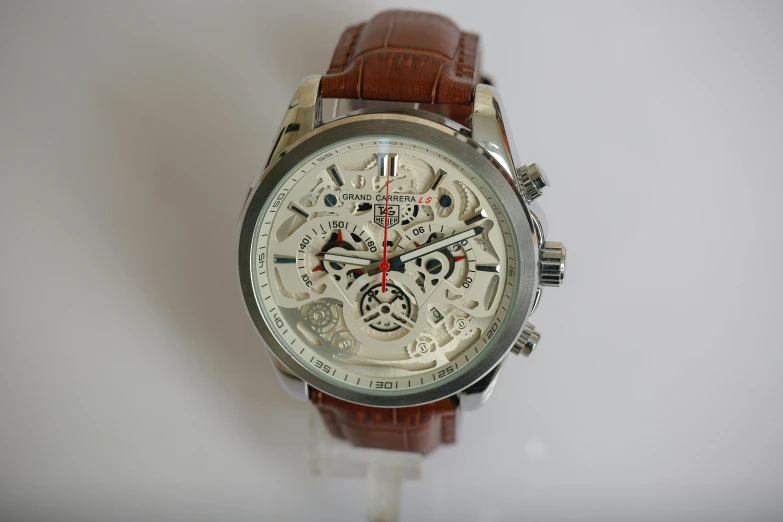 an image of a silver watch with brown straps