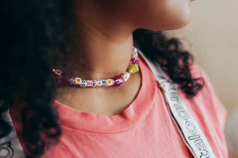 a woman with a crown necklace on