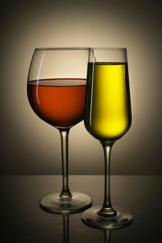 two wine glasses with different colored wines