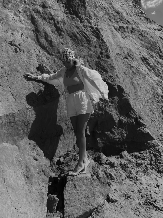 a black and white po of a woman on the side of a mountain