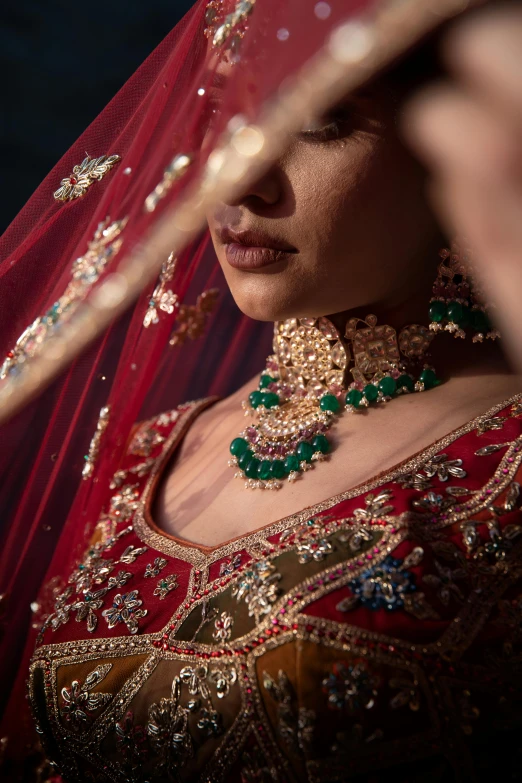 a close up of a woman in a wedding dress wearing jewelry