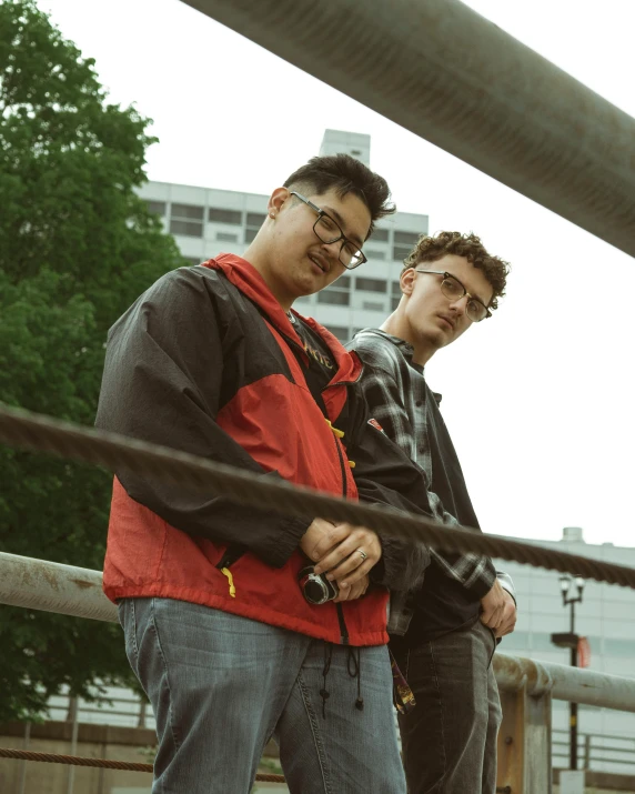 two men with glasses are standing next to each other