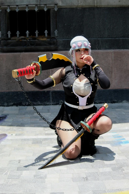 a woman in black outfit kneeling with two weapons