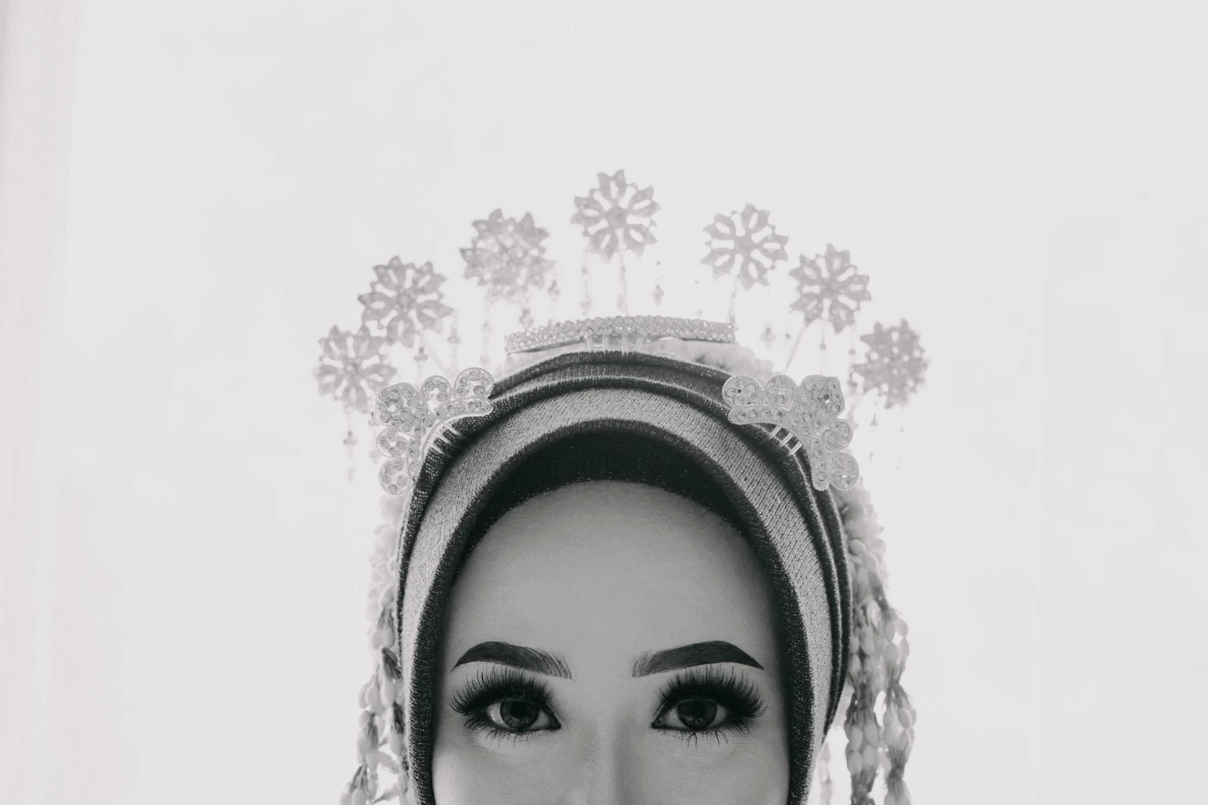 black and white po of a woman in an ethnic headdress