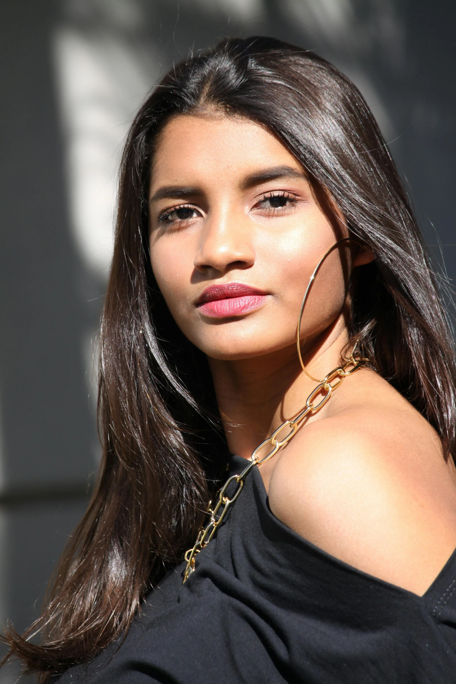 woman with long hair wearing a chain around her neck