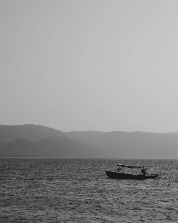 two people are in a boat out in the water