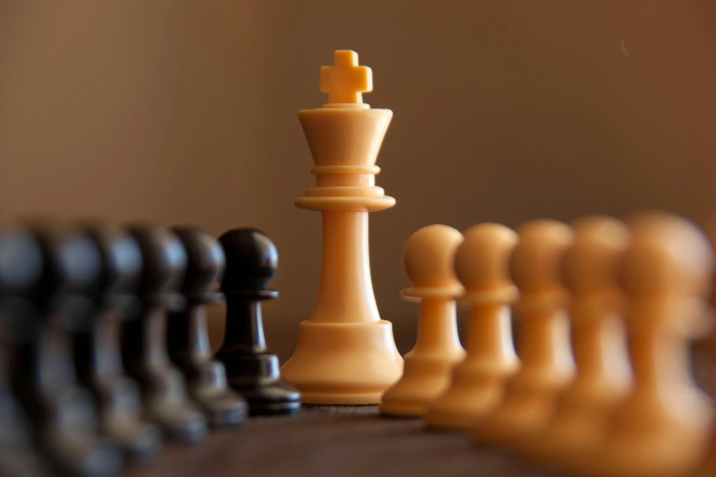 a chess set with wooden pieces standing together