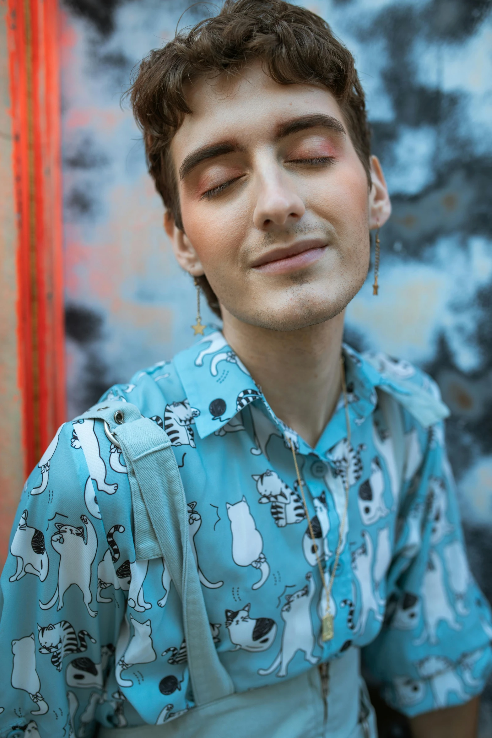 a man wearing a blue shirt and smiling at the camera