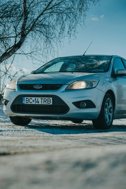 an image of a white car parked in the snow