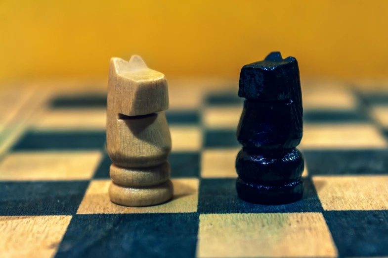 two pawns placed side by side on a chess board