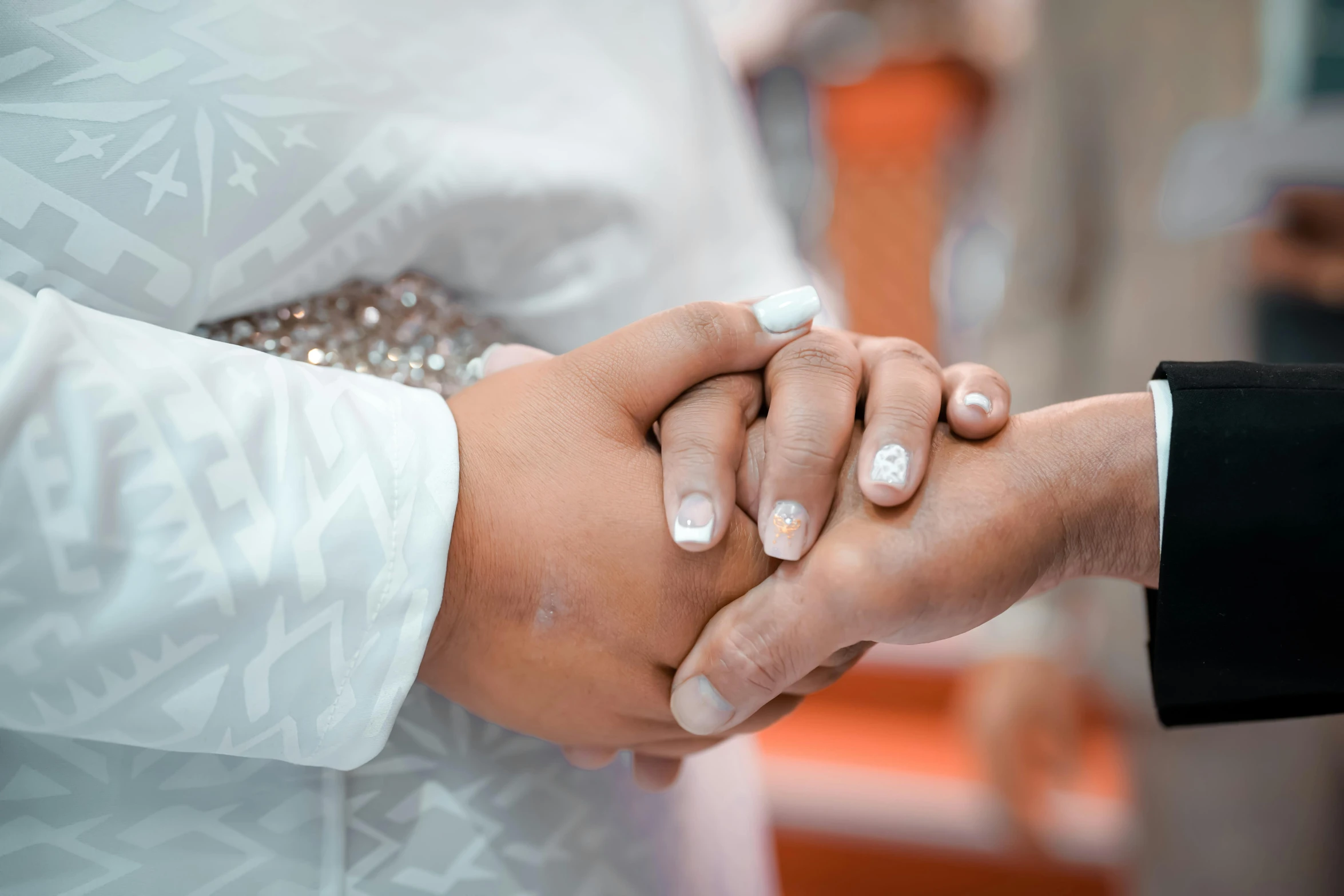 a newly married couple hold hands at the alter