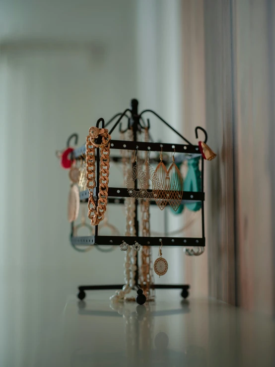 various pieces of jewelry are on display on a stand