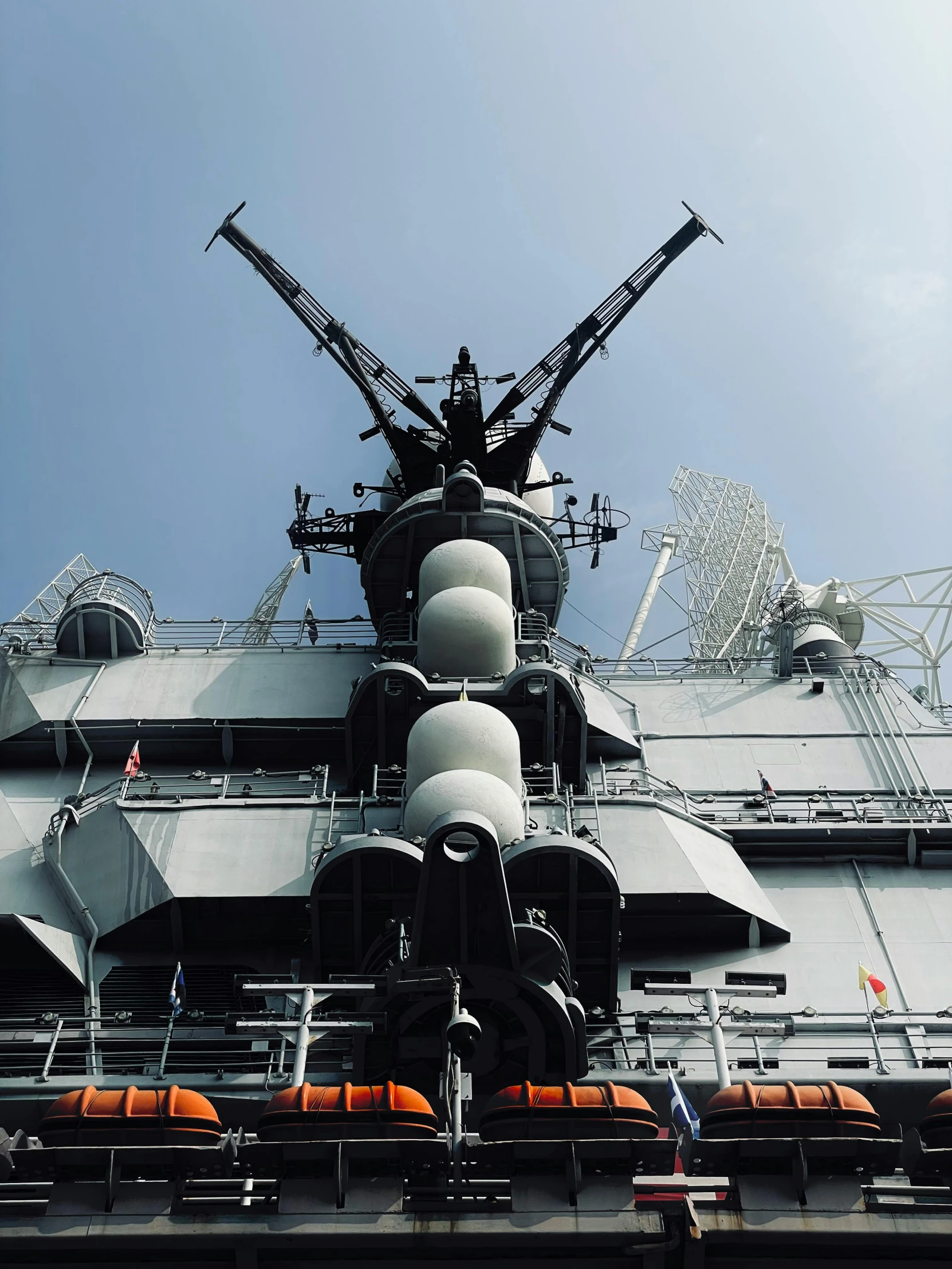 a large battleship sitting next to a ferris wheel