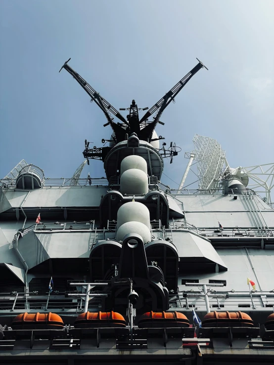 a large battleship sitting next to a ferris wheel