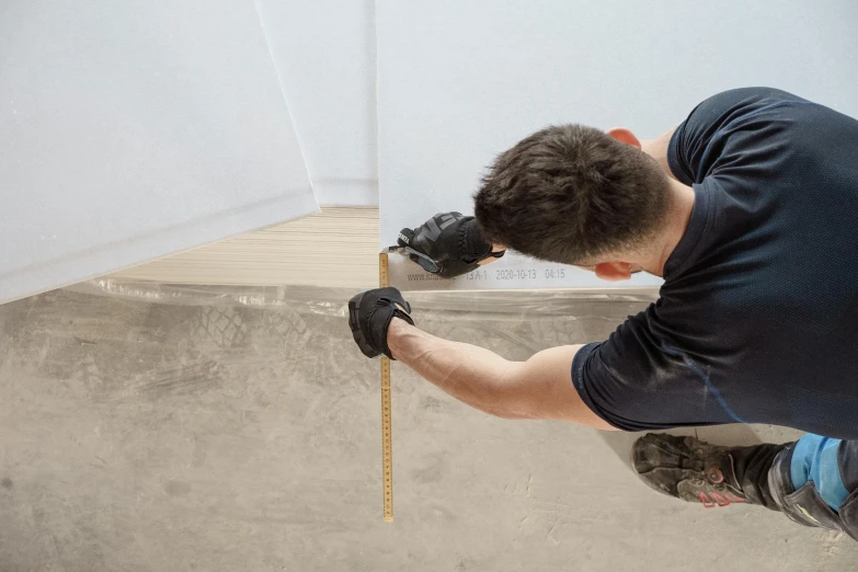 the man is repairing a glass window with tools