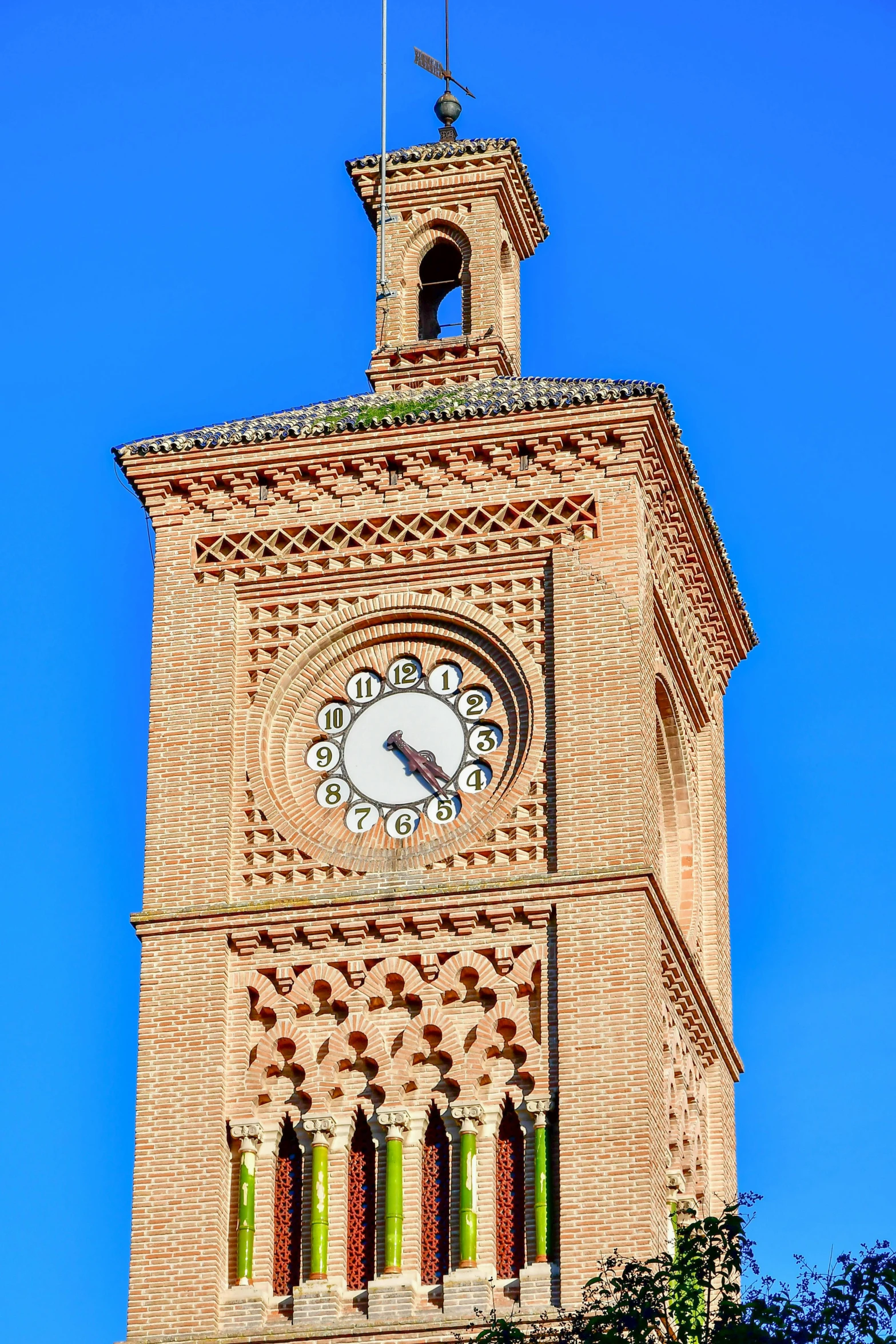 a large clock tower against a bright blue sky