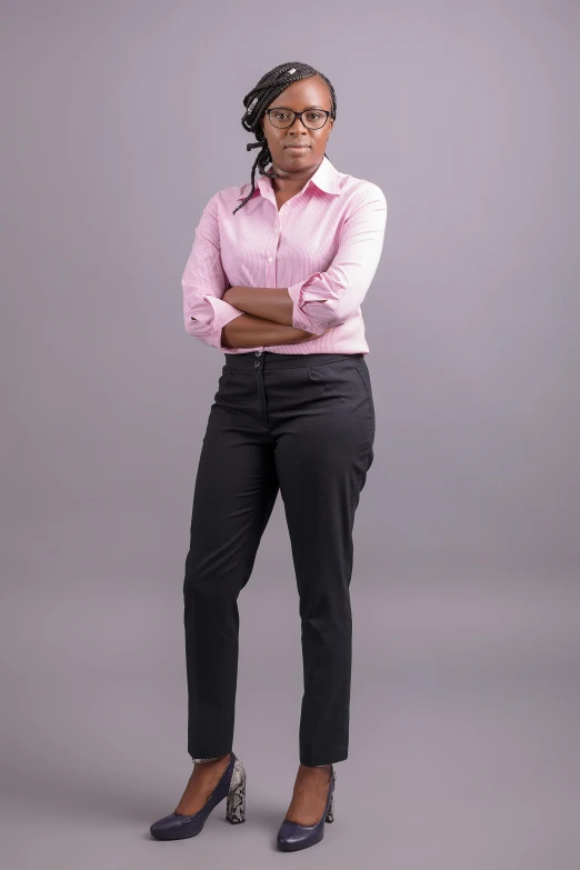 a woman wearing a pink shirt and black pants