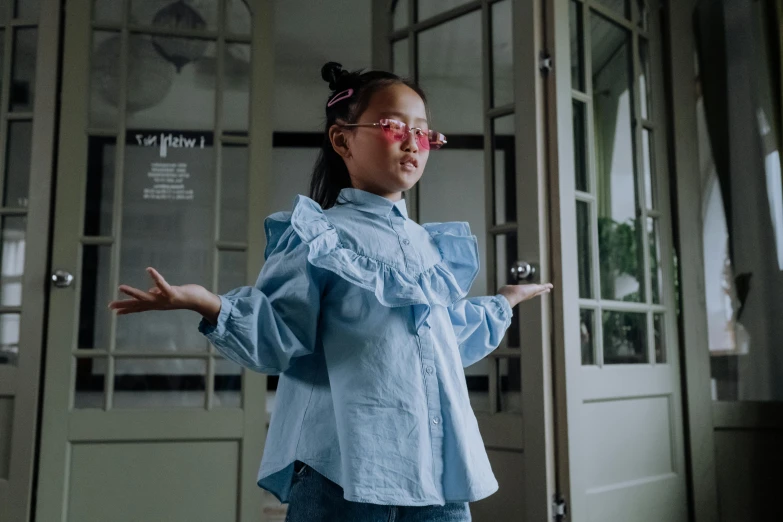 girl standing in front of a door with her hands out