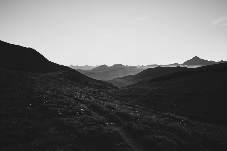 a black and white landscape shows a rocky hill