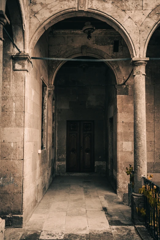 an entrance to a building with stone walls