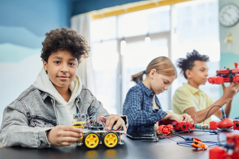 young children play with electronic toys at the table