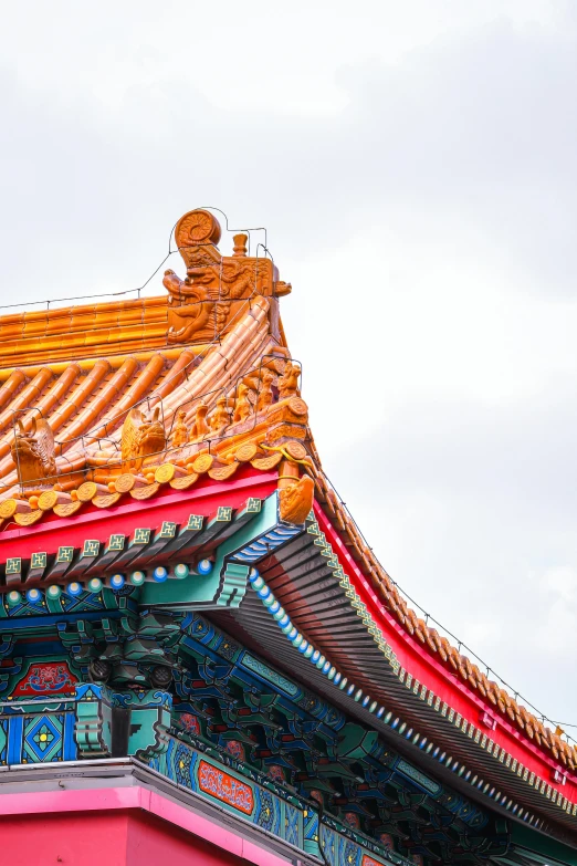 an oriental building with blue, pink and yellow colors