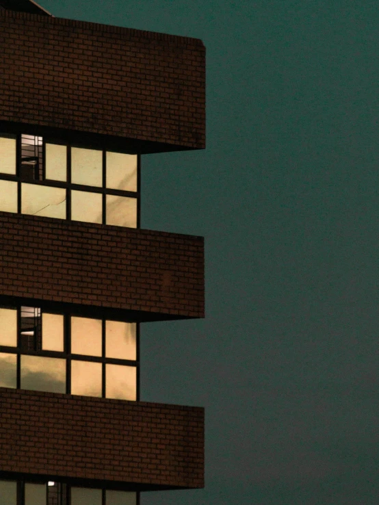 a plane flies by an apartment building with many windows