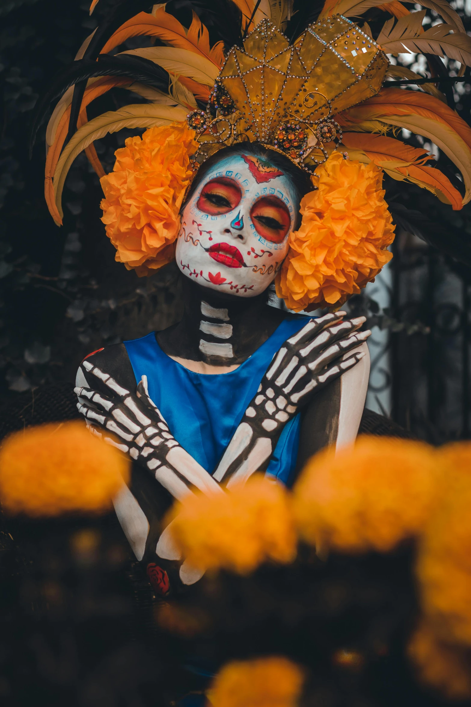 a skeleton in a costume holding up a skull