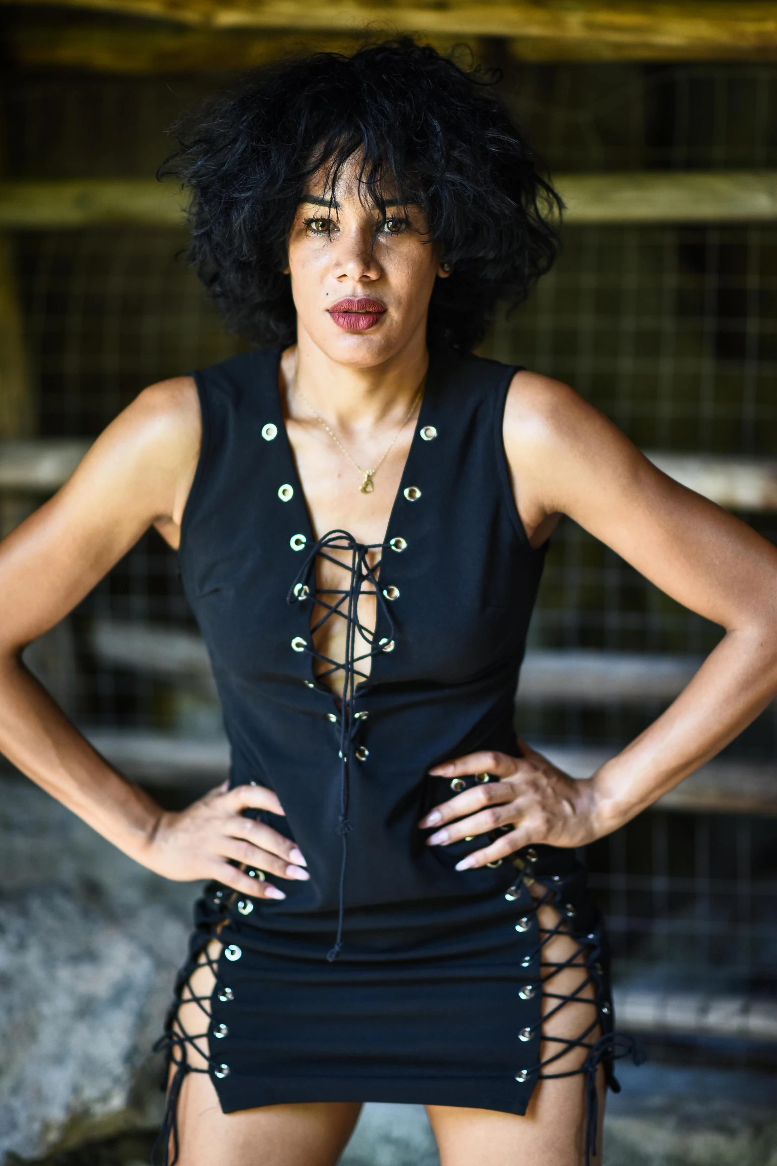 a woman with dark hair wearing black and wearing  lingerie