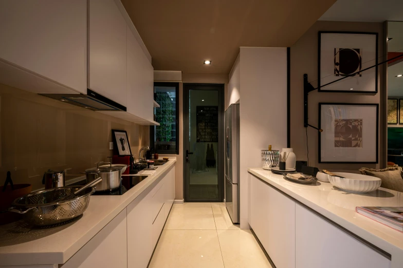 an kitchen that has white counters with sinks