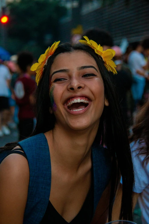 a girl with yellow flowers in her hair and a smile