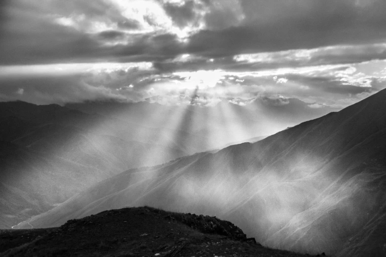 black and white po of rays streaming through the clouds