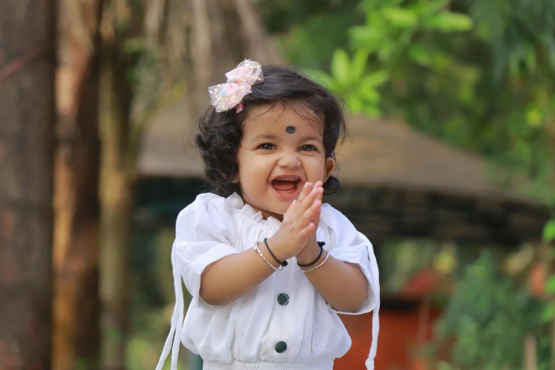  smiling and raising hands at camera