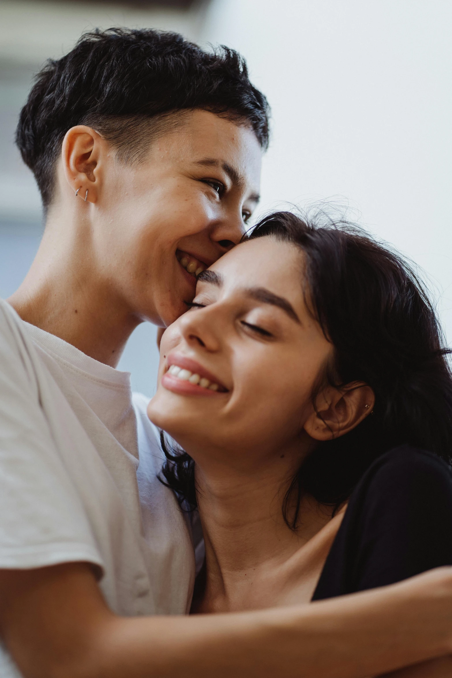 a smiling woman and a smiling man who are both emcing each other