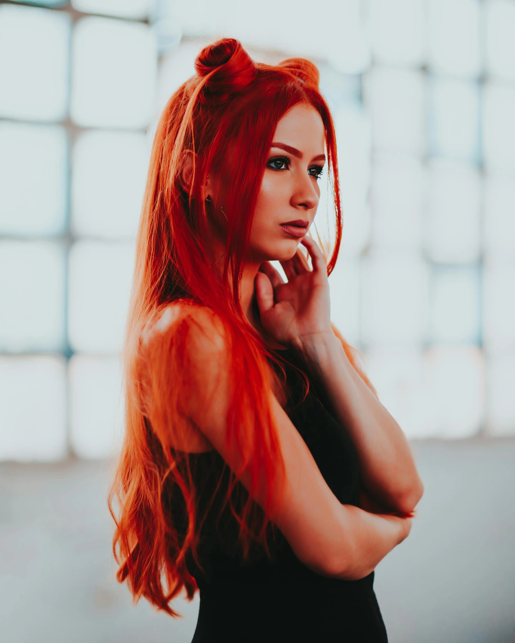 a woman with red hair and ponytails with long bangs