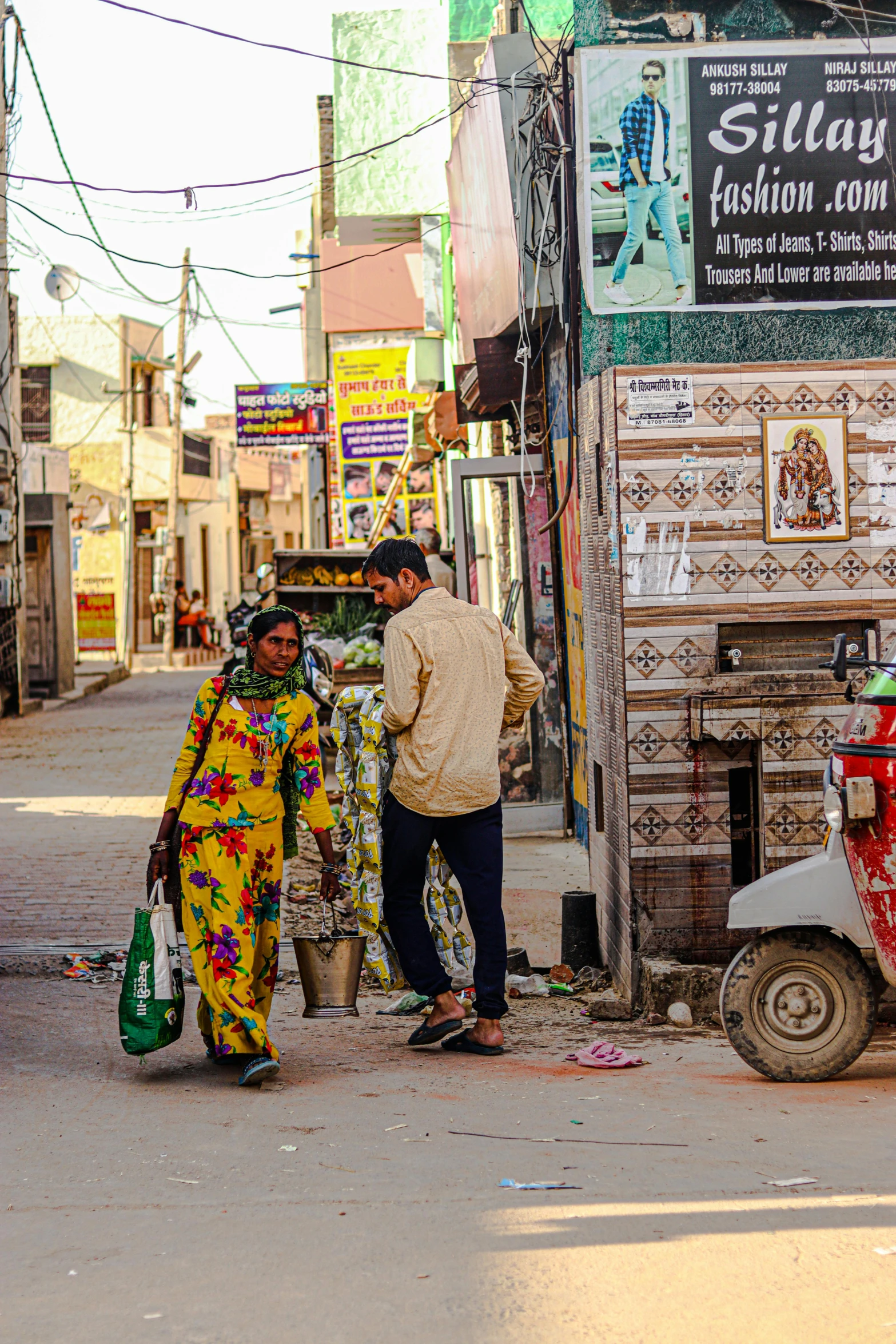 two women walking down a road next to an old truck