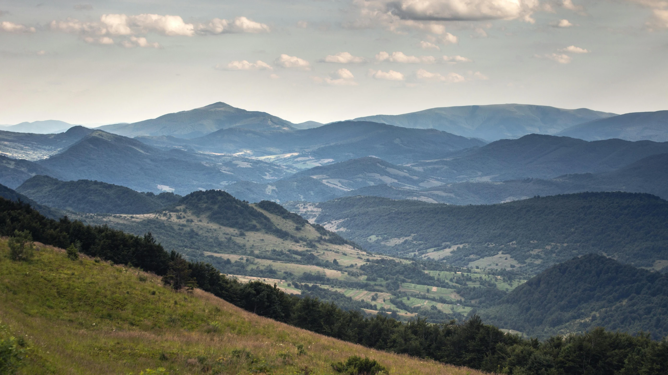 a mountain range on a hill with rolling hills in the background